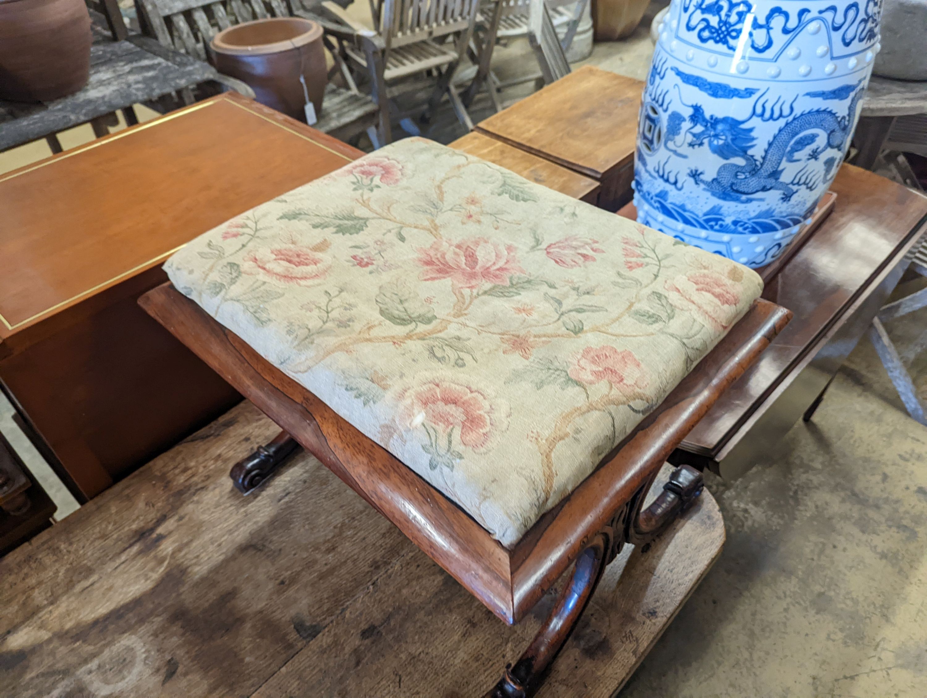 An early Victorian rectangular rosewood X frame dressing stool, length 59cm, depth 48cm, height 42cm